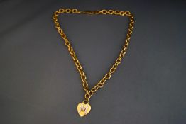 A hollow link necklace, stamped '375', with a heart shaped initial M pendant,