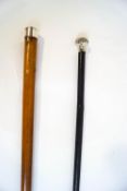 A pair of walking canes with silver tips,