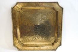 A Chinese brass tray with engraved dragon decoration and character mark to centre,