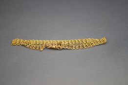 A bracelet, stamped '585', of three strand filed curb links, 8.