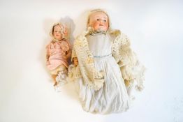 An early 20th century Gebruder Heubach baby doll with bisque head, composite body, arms and legs,