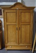 A Victorian pine double wardrobe with drawer to base,