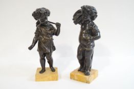 A pair of 19th century bronze figures of semi-clad children, one with a sheaf of corn,