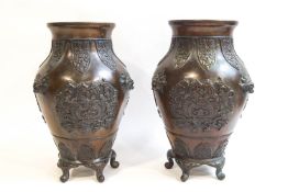 A pair of 19th century Chinese bronze vases with petal and phoenix decoration in relief,