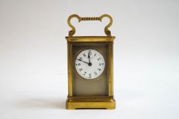 A brass carriage clock, the enamel dial signed Racine & Co, Dublin,