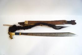 A Bornean head hunters sword or mandau, with animal hair plait to bone handle,