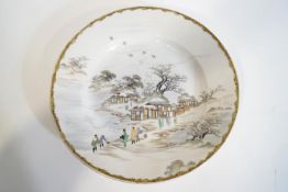 A Japanese porcelain plate, painted with figures in a village, red painted marks to base, 28.