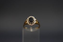 A sapphire and diamond 9 carat gold cluster ring, finger size M, 2.