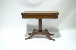 A rosewood card table with William IV crossbanded top on later mahogany base with four splayed legs,