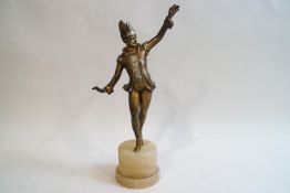 An Art Deco style spelter figure of a costumed male dancer, on an alabaster plinth,