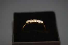 A five stone diamond ring, stamped 'Pt 18ct', finger size P, 1.