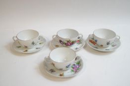 A set of four 20th century Dresden cups and saucers with hand painted floral decoration,