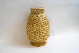 A Royal Worcester vase modelled as a basket weave vessel with trailing flowers,