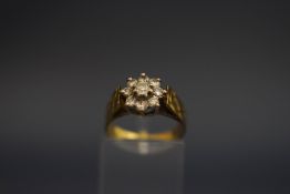 A nine stone diamond flower head 18 carat gold cluster ring,