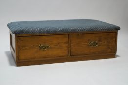 An Edwardian upholstered pine ottoman with two drawers,