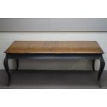 A French style oak dining table with ebonised apron and cabriole legs, and two additional leaves,