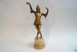 An Art Deco style spelter figure of a female dancer on an alabaster base,