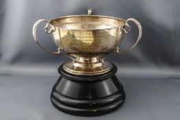 A silver round bowl with three leaf capped scroll handles, London 1907, 17cm diameter, 21cm overall,