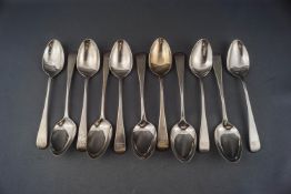 A set of eleven William IV silver old English pattern tea spoons with script initials,