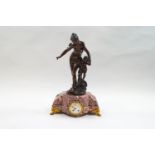 A late 19th century French mantel clock, surmounted by a figure a scantily clad female and cherub,