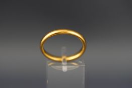 A 22ct gold court-shaped wedding ring, London 1929, re-shaped to an oval band, size not possible,