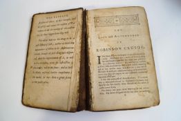 An 18th century copy of The Life and Adventures of Robinson Crusoe, with half calf binding,