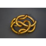 A Victorian gilt metal part foliate engraved knot brooch, 5.6 cm wide.