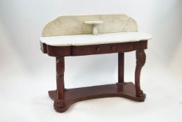 A Victorian stained wood washstand with shaped white marble top, on carved scroll supports,