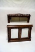 A Victorian mahogany mirror back chiffonier, with marble top above mirrored cupboard doors,