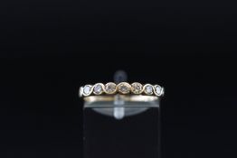 A 9ct gold and diamond seven stone half-eternity ring, the round brilliants approx. 0.