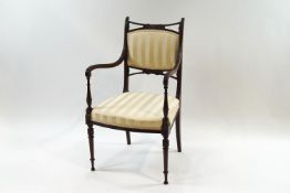 An early 20th century Regency style mahogany open arm occasional chair, having reeded arms,