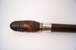 A stout walking stick with wide silver collar (rubbed) and decorative knop carved with deers