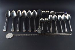 A collection of silver flatware, comprising; set of six feather-edge tea spoons and sugar tongs,