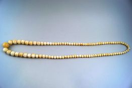 An early 20th century single row ivory bead necklace,