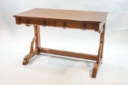 A Victorian Gothic revival oak writing table in the manner of Augustus W N Pugin, with two drawers,