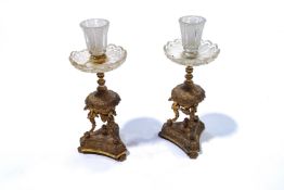 A pair of 19th century Regency style gilt metal candlesticks with hobnail cut glass holders and