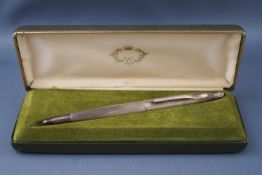 A silver mounted and engine turned biro, engraved 'J.R.C. Gough', Birmingham 1976, in a box.