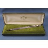 A silver mounted and engine turned biro, engraved 'J.R.C. Gough', Birmingham 1976, in a box.