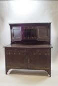 An Arts and Crafts style stained oak dresser,