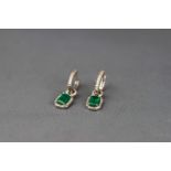 A pair of emerald and diamond pendent earrings,