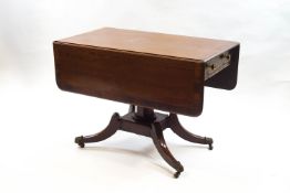 A 19th century mahogany Pembroke table on quatre form base, outswept legs and brass casters,