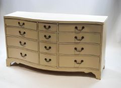 A 20th century white painted serpentine chest of twelve drawers, 86.