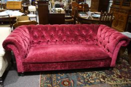 A Victorian style sofa with button back and turned legs