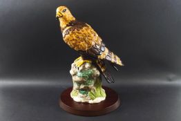 A Royal Doulton figure of 'Golden Eagle' part of the Birds Of Prey collection RDA36 with a wooden