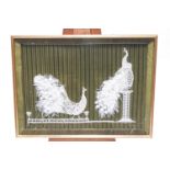 A lace and crochet picture of two peacocks mounted a green striped fabric background, by Joan Payne,