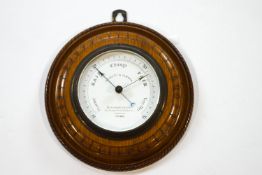 A Negretti & Zambra oak circular barometer, the dial signed and numbered 25943, 22.