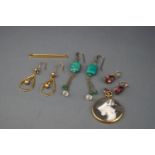 Three pairs of earrings, a locket and a tie pin,