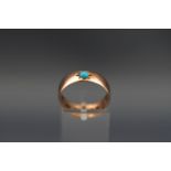 A 9ct rose gold wedding band, later star-gypsy set with a small round cabochon turquoise, ring,