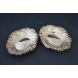 A pair of modern silver shaped oval sweet dishes, each embossed with flowers,