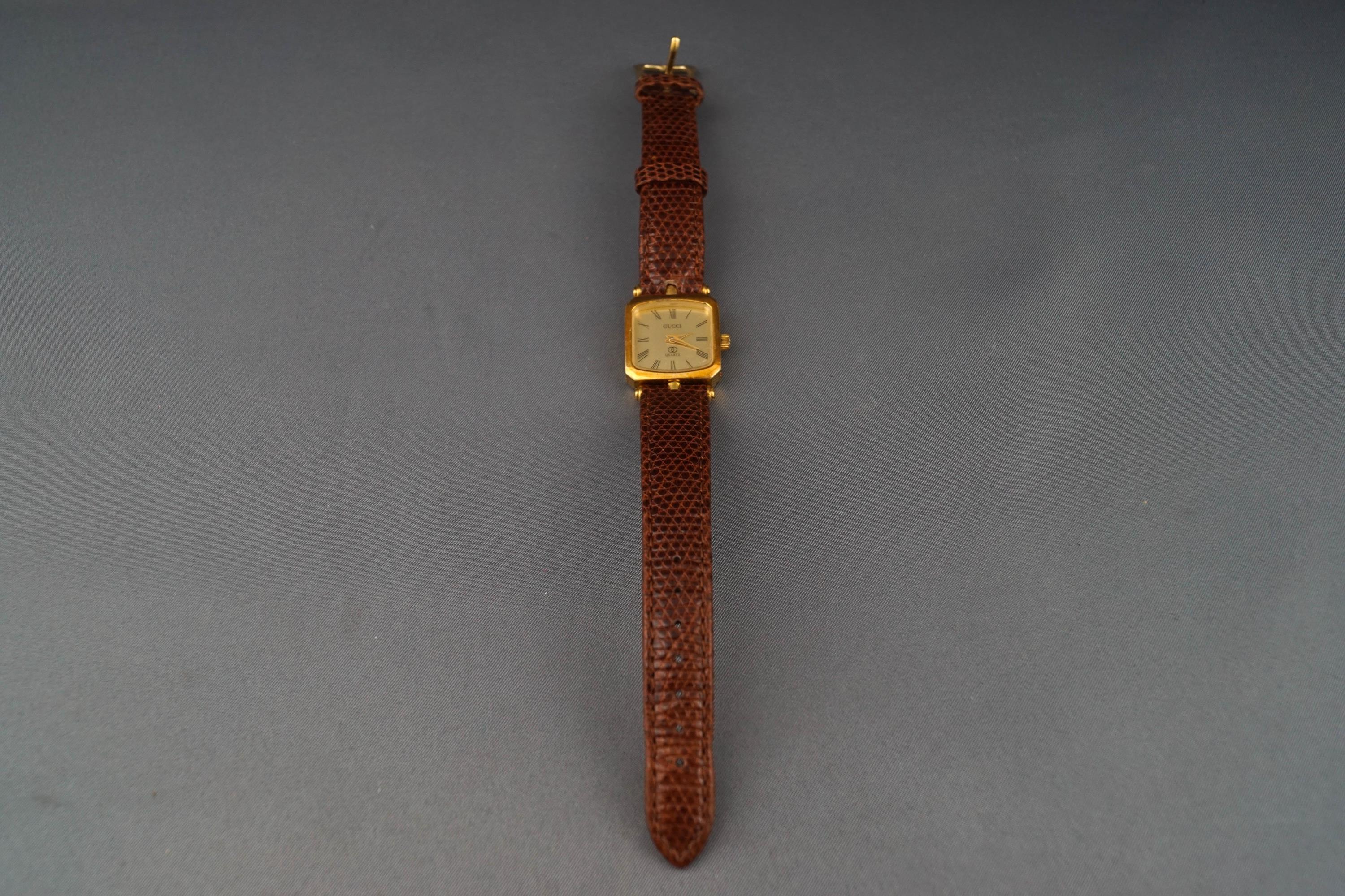 A Gucci quartz, a lady's gold plated oblong wrist watch, - Image 2 of 2